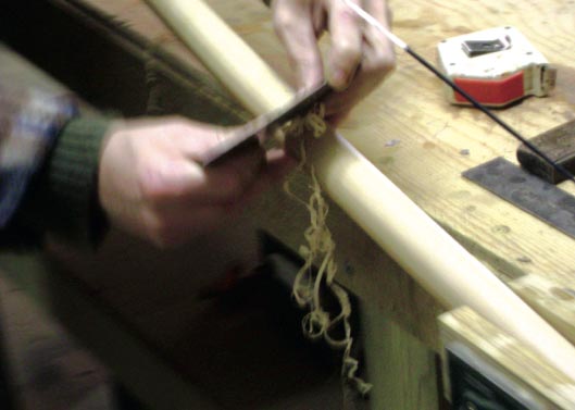 Steve uses a cabinet scraper to remove paper thin layers of wood to bring the limb round just as he wants it.